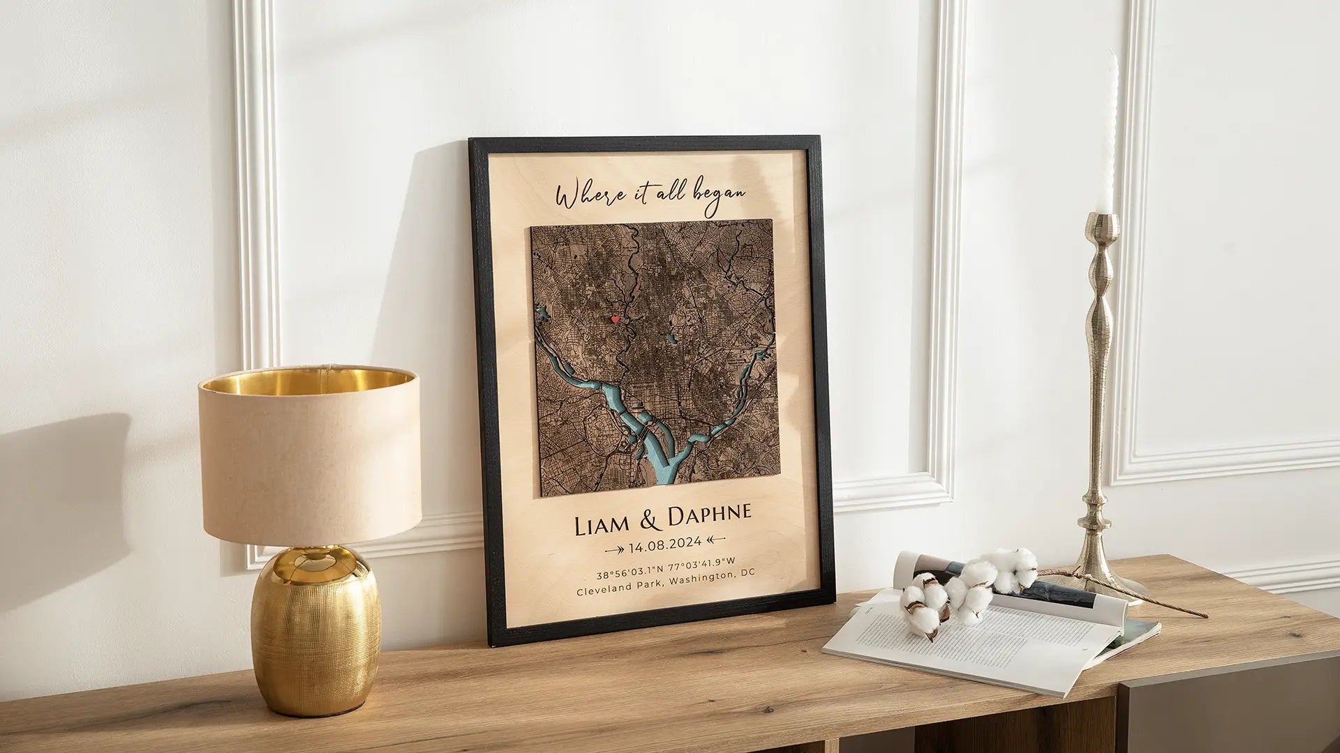 Personalized wood map frame on a console table with lamp and decor, featuring custom location map and names.