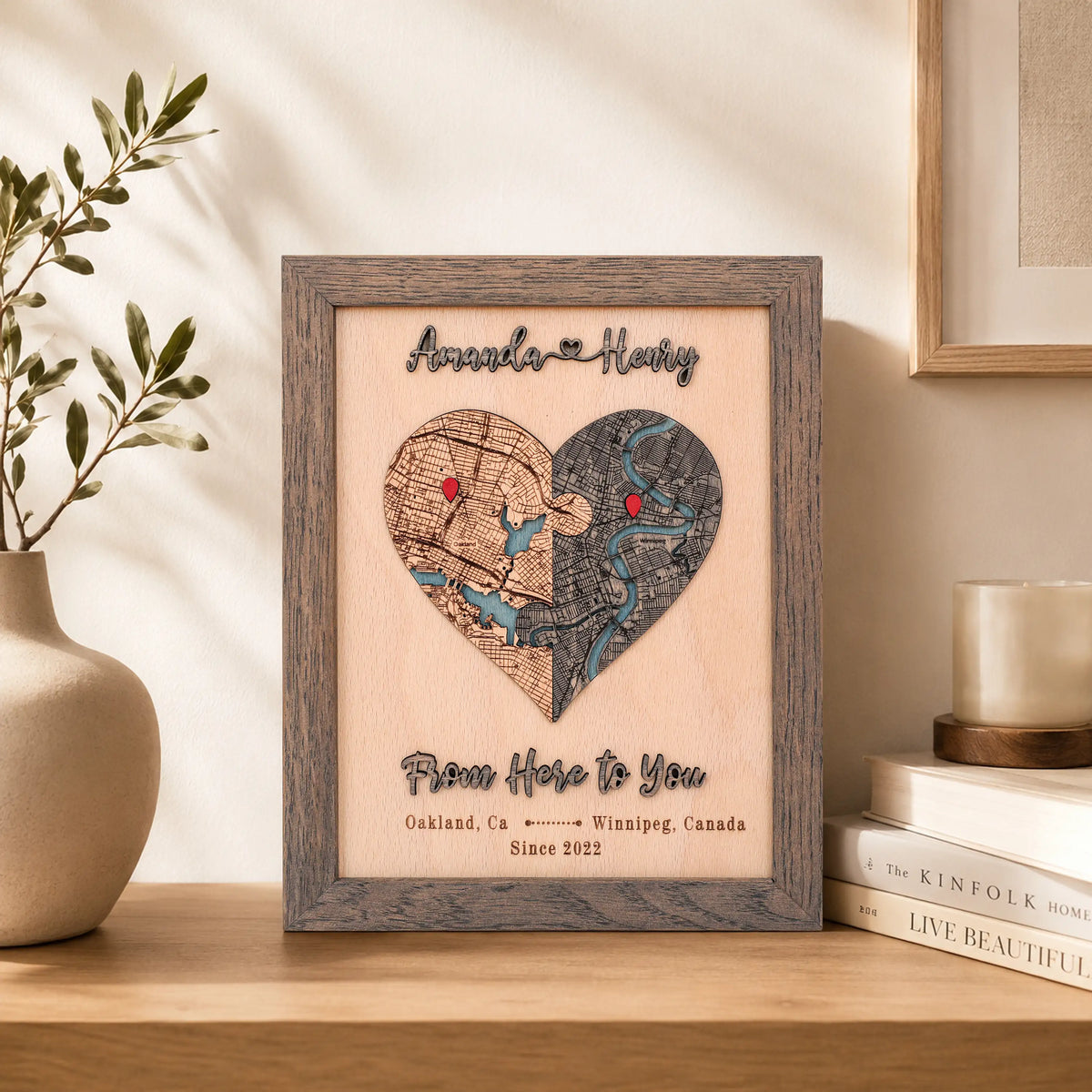 Custom anniversary map in grey oak frame displayed on a shelf with raised wooden lettering and personalized locations.
