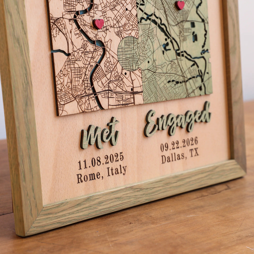 Close-up of custom engagement map with raised 3D Met and Engaged lettering, dates, locations, and sage frame.