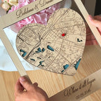 Custom heart-shaped wooden map in frame held in hands personalized with names and special date