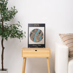 Personalized framed wooden location map displayed on side table, custom housewarming gift for new home with welcome home text