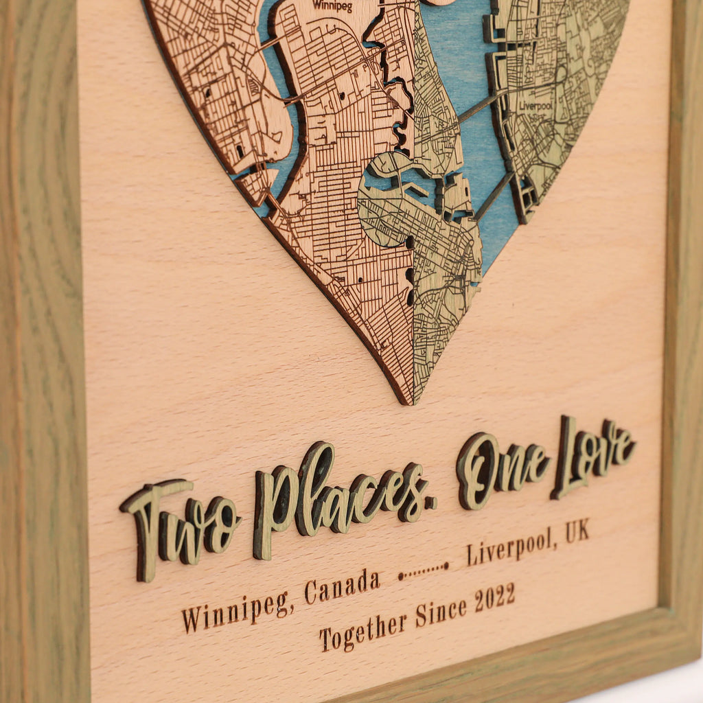 Close-up of custom love story map with raised 3D wooden phrase, personalized cities, date, and sage frame.