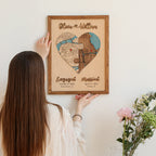 Custom wedding gift map being placed on the wall, featuring two locations, raised wooden names, and milestone dates.