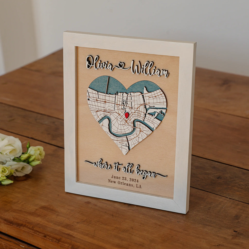Custom Where It All Began wooden map frame displayed on rustic table, personalized with couple names, wedding date, and New Orleans location.