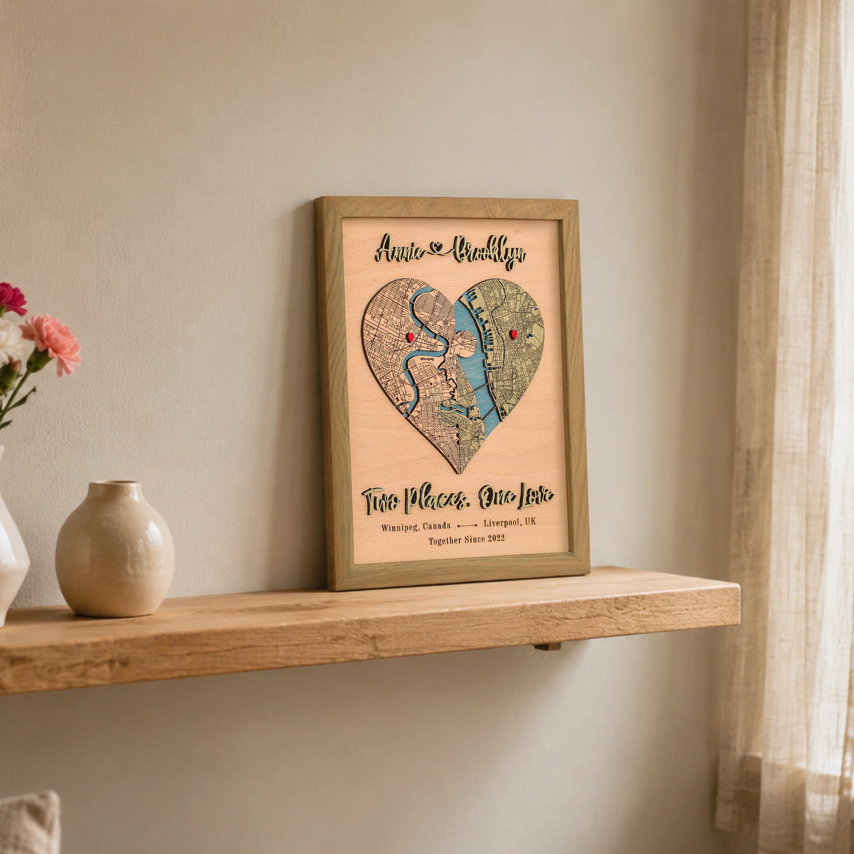 Custom wooden love map in sage frame styled on a shelf, personalized with two locations and raised 3D text.
