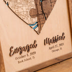 Close-up of engaged and married 3D lettering with personalized dates and locations on a custom wooden wedding map.