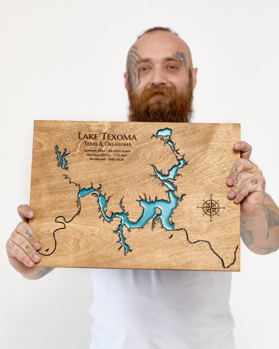 Man holding a wooden map of Lake Texoma