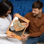Couple holding personalized First Home heart map as meaningful housewarming gift