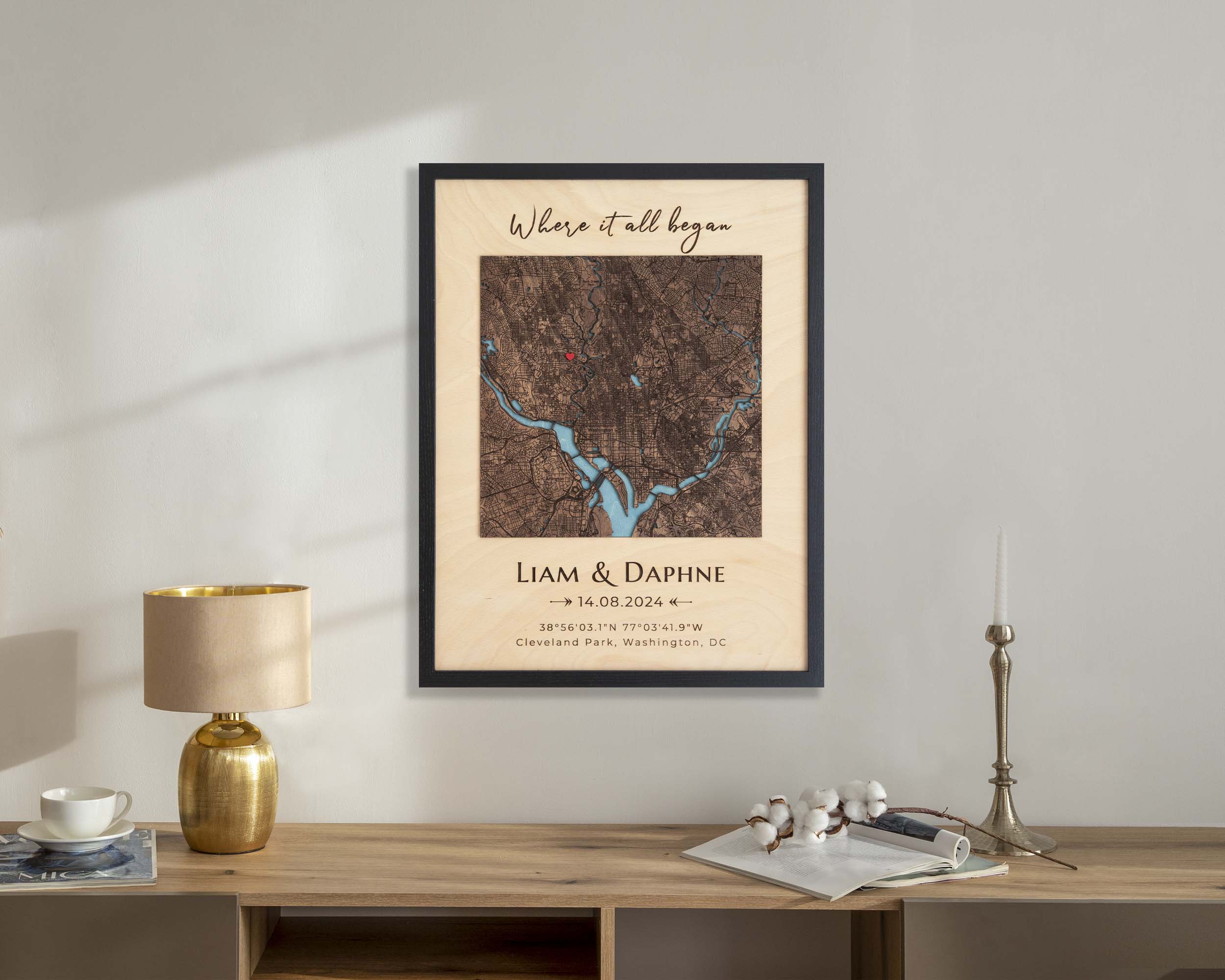 Framed map print on a wall above a wooden desk with decorative items.
