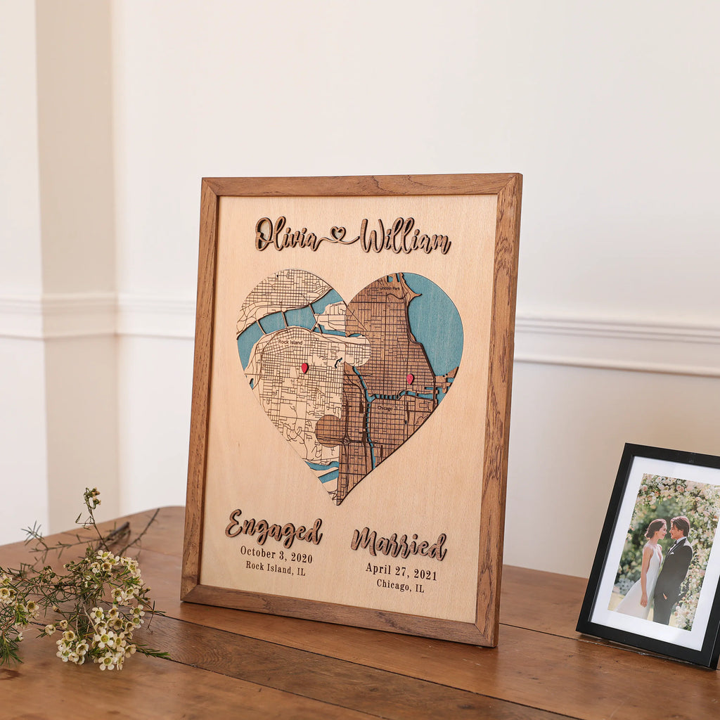 Framed wedding location map keepsake displayed with flowers and wedding photo, personalized with names, dates, and places.