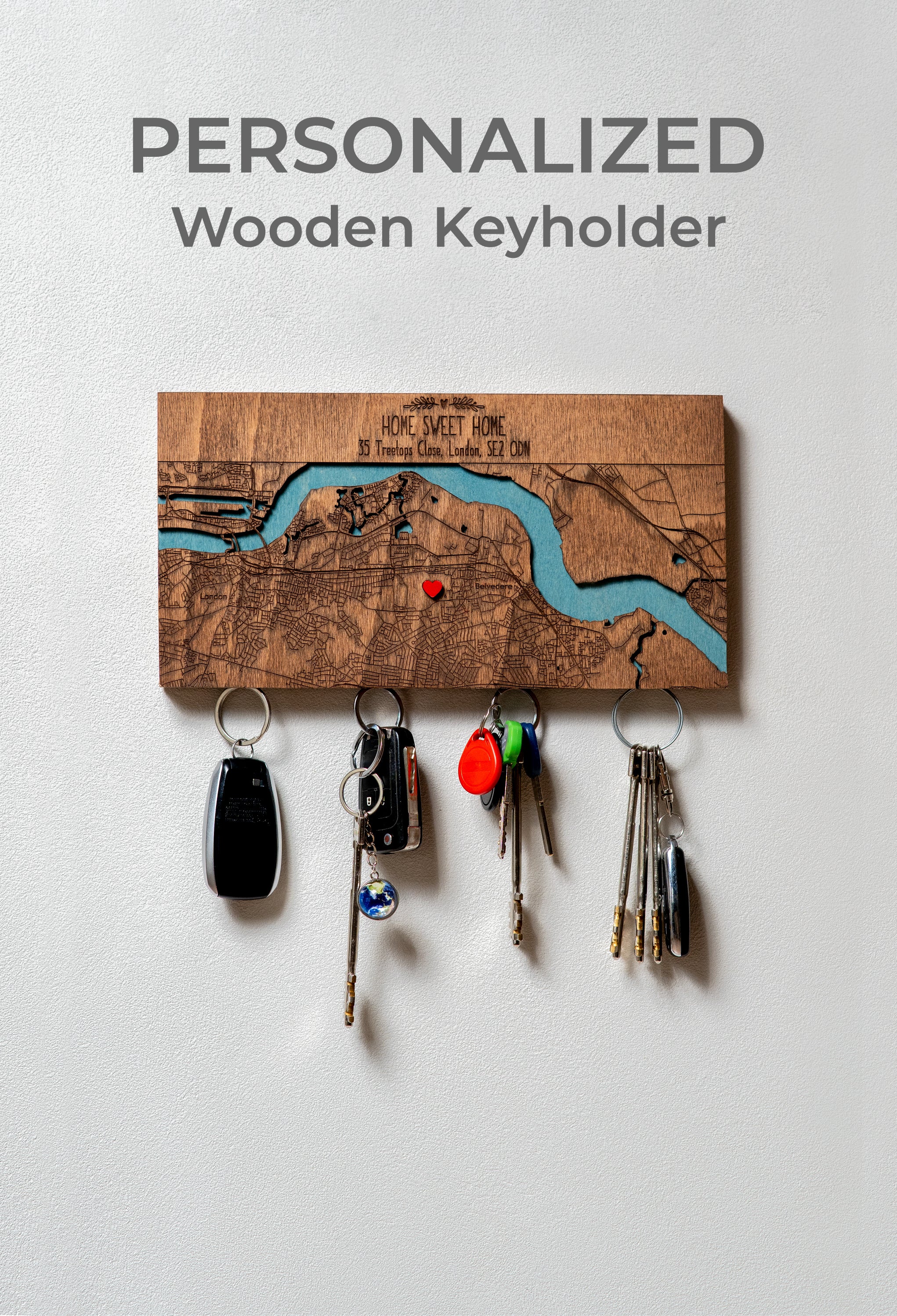 Personalized wooden keyholder with keys on a light gray background