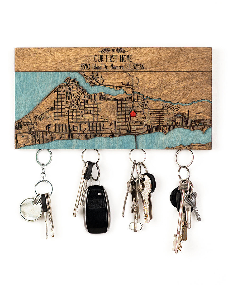 Key holder with engraved map design and keys attached on a white background