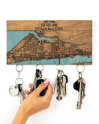 Key holder with map design and keys attached, against a white background