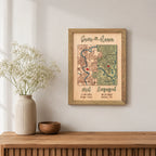 Met and Engaged custom map wall decor in sage frame with two locations, red pins, dates, and raised 3D lettering.
