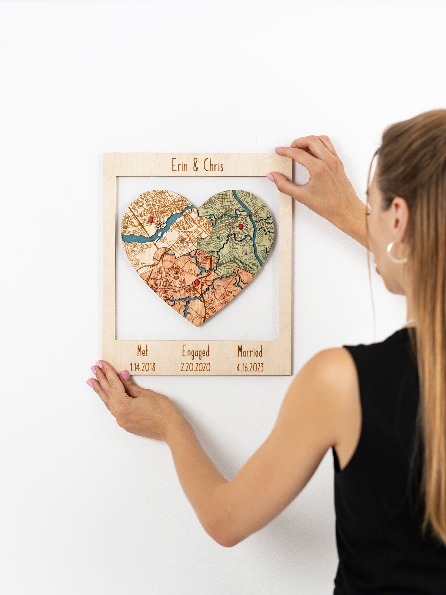 Customized heart-shaped map puzzle in a wooden frame commemorating the meeting, engagement, and marriage locations of a custom name with significant dates. custom wedding and anniversary gift