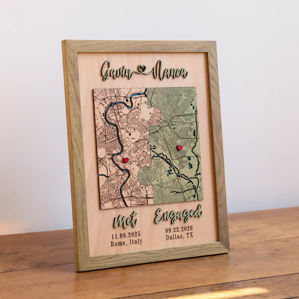 Personalized engagement map in sage square frame with two custom locations, raised 3D names, and milestone text.