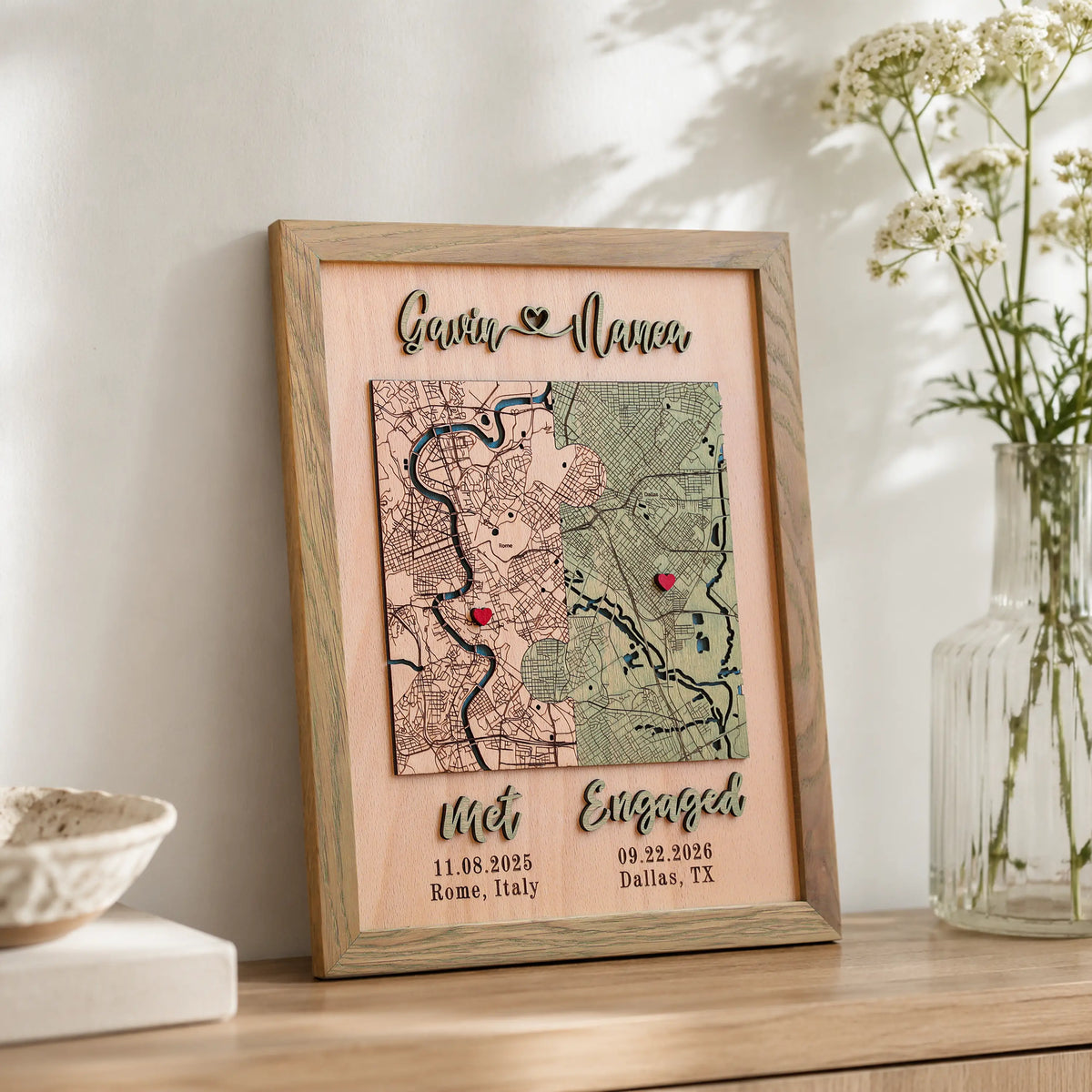 Personalized engagement map in sage frame displayed on a shelf with custom dates, locations, and romantic wording.