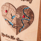 Detailed view of personalized heart location map with layered wood streets, blue rivers, red pins, and custom places.
