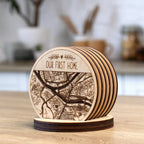 Personalized engraved wooden map coasters in holder, angled close-up view of custom city map coaster set