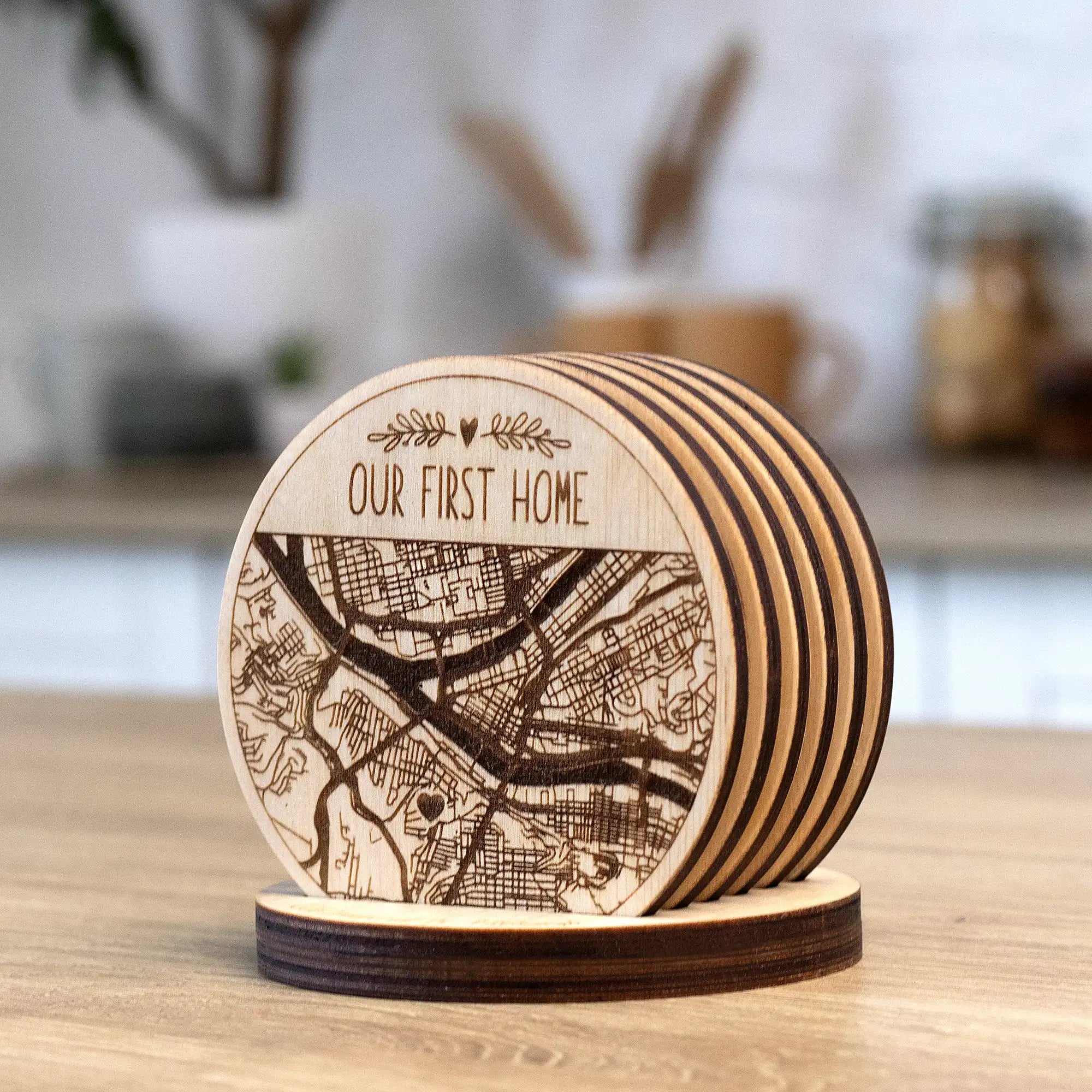 Personalized engraved wooden map coasters in holder, angled close-up view of custom city map coaster set