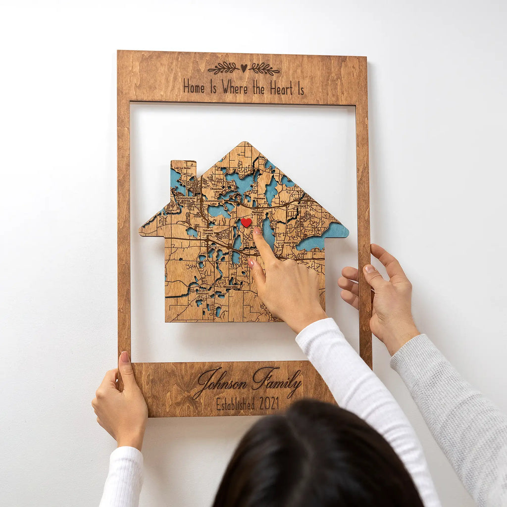 Detail of house-shaped wooden address map with red heart marker, personalized framed new home wall art for housewarming gift