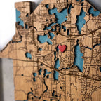 Close view of personalized new home gift framed address map being placed on wall, custom wooden housewarming keepsake