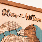 Detail of raised wooden couple names on a personalized wedding map with heart-shaped city map and natural wood finish.