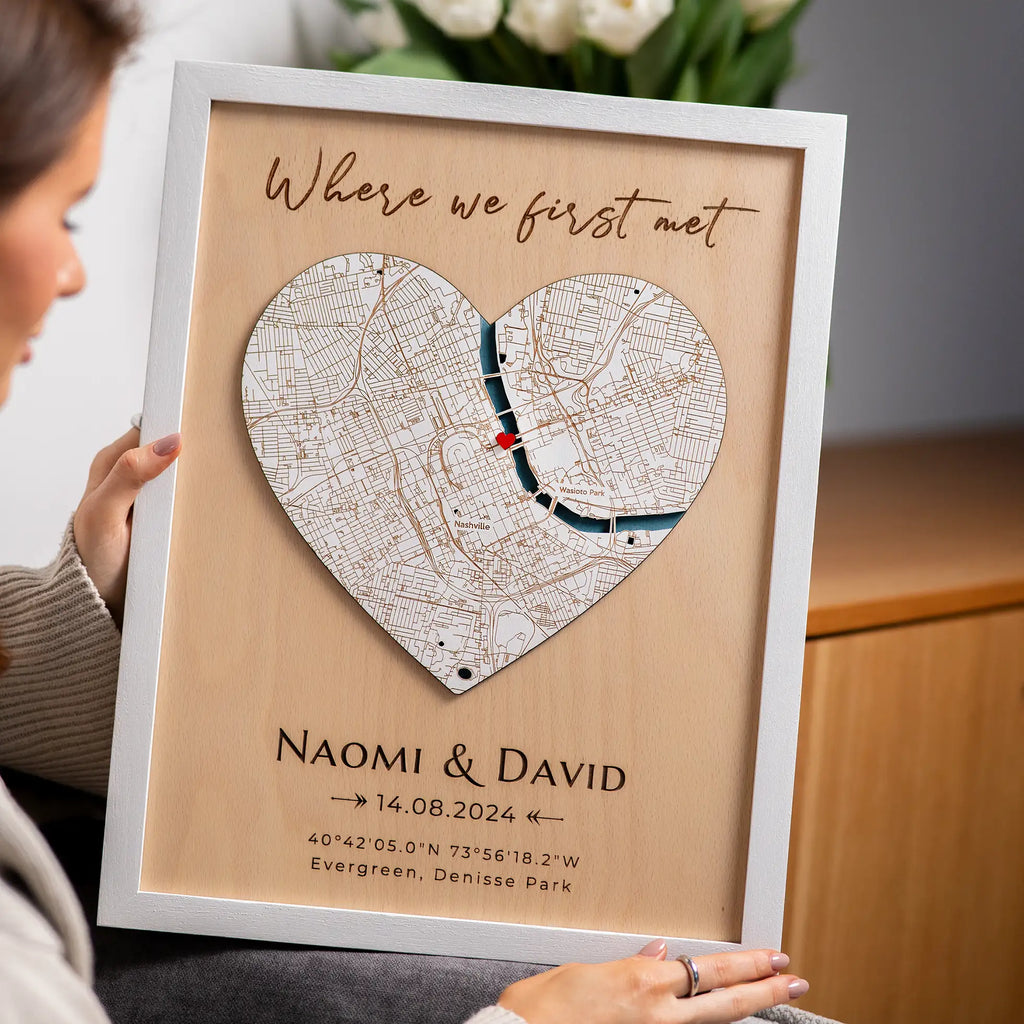 Woman holding personalized Where We Met plaque map in white frame with names date and custom location