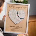 Woman holding personalized Where We Met plaque map in white frame with names date and custom location