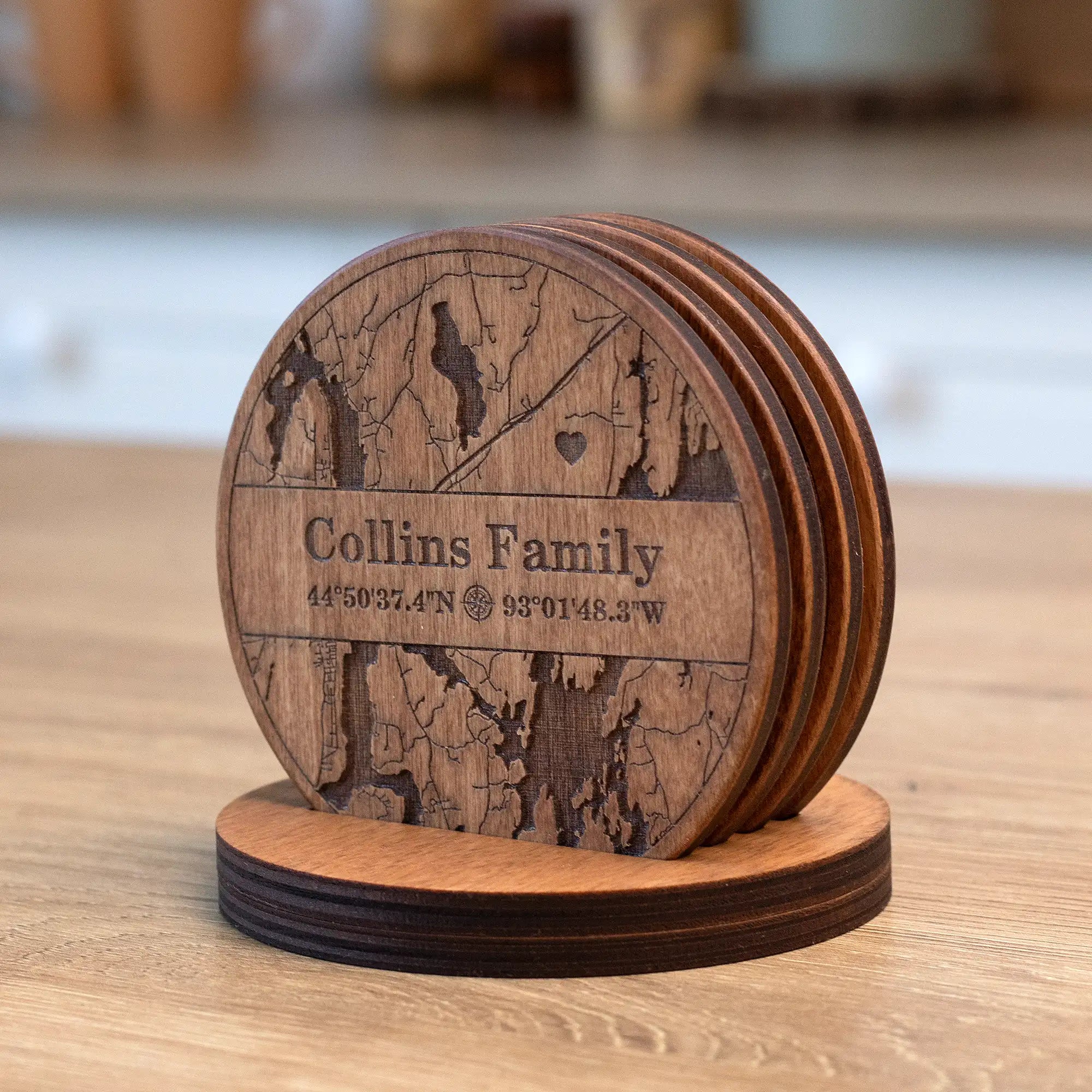 Personalized wooden coasters for housewarming in matching holder with engraved family map design