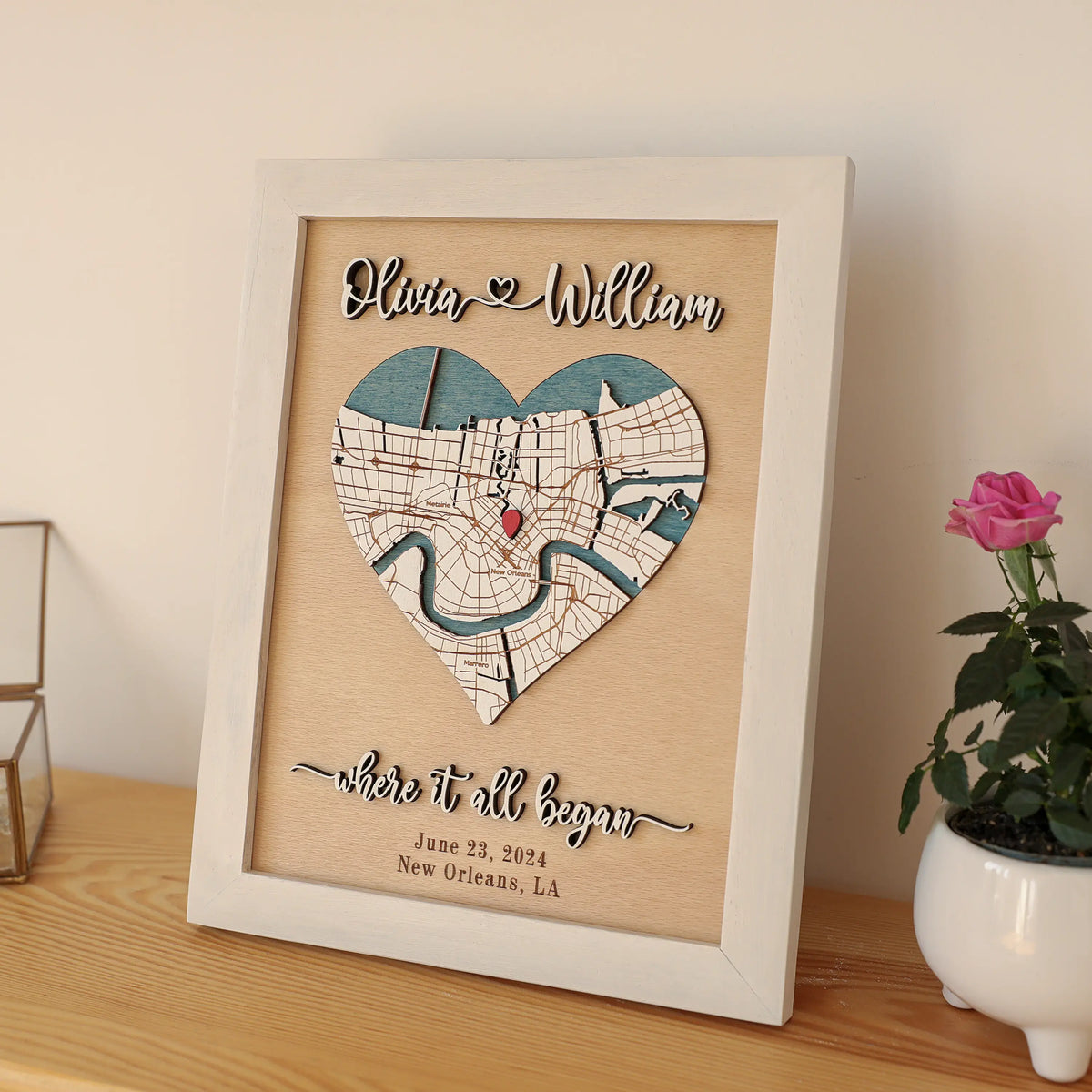 Personalized wooden heart map anniversary gift for couple, featuring custom New Orleans location, names, date, and white framed 3D wall art display