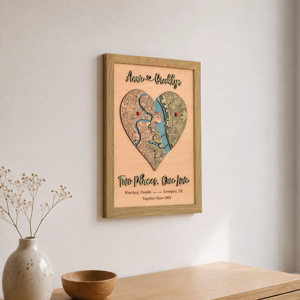 Personalized wooden heart map in sage frame displayed on a wall with custom locations and romantic wording.