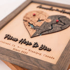 Close-up of personalized wooden love story map with raised 3D lettering, custom locations, and grey oak frame.