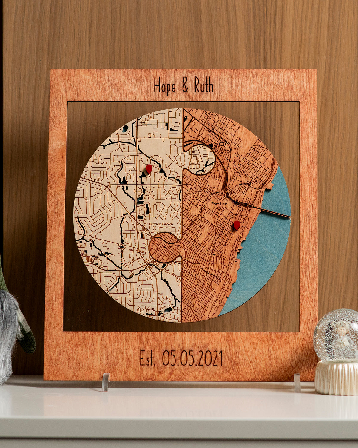 Wooden puzzle piece with engraved map design on a wooden surface