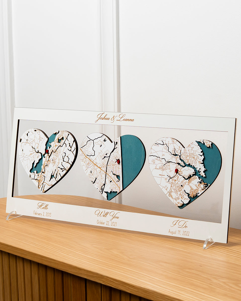 Heart-shaped map artwork with personalized text on a wooden surface
