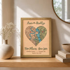 Two-location love map in sage frame displayed on a wooden shelf with raised names, red pins, and custom places.