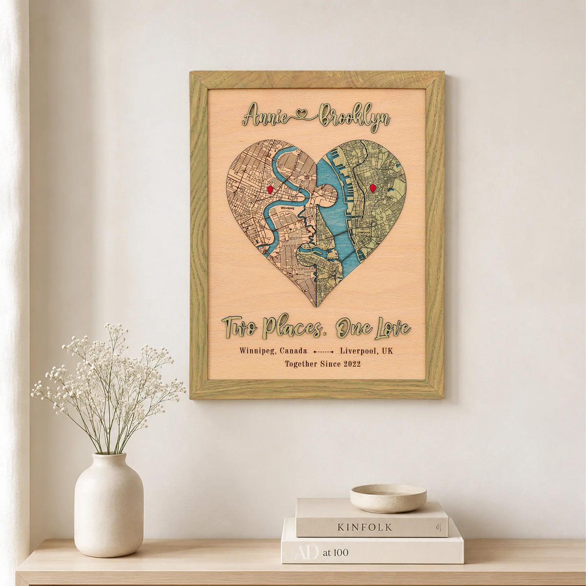 Two Places One Love wooden map in sage frame displayed on a wall with custom locations and raised 3D lettering.