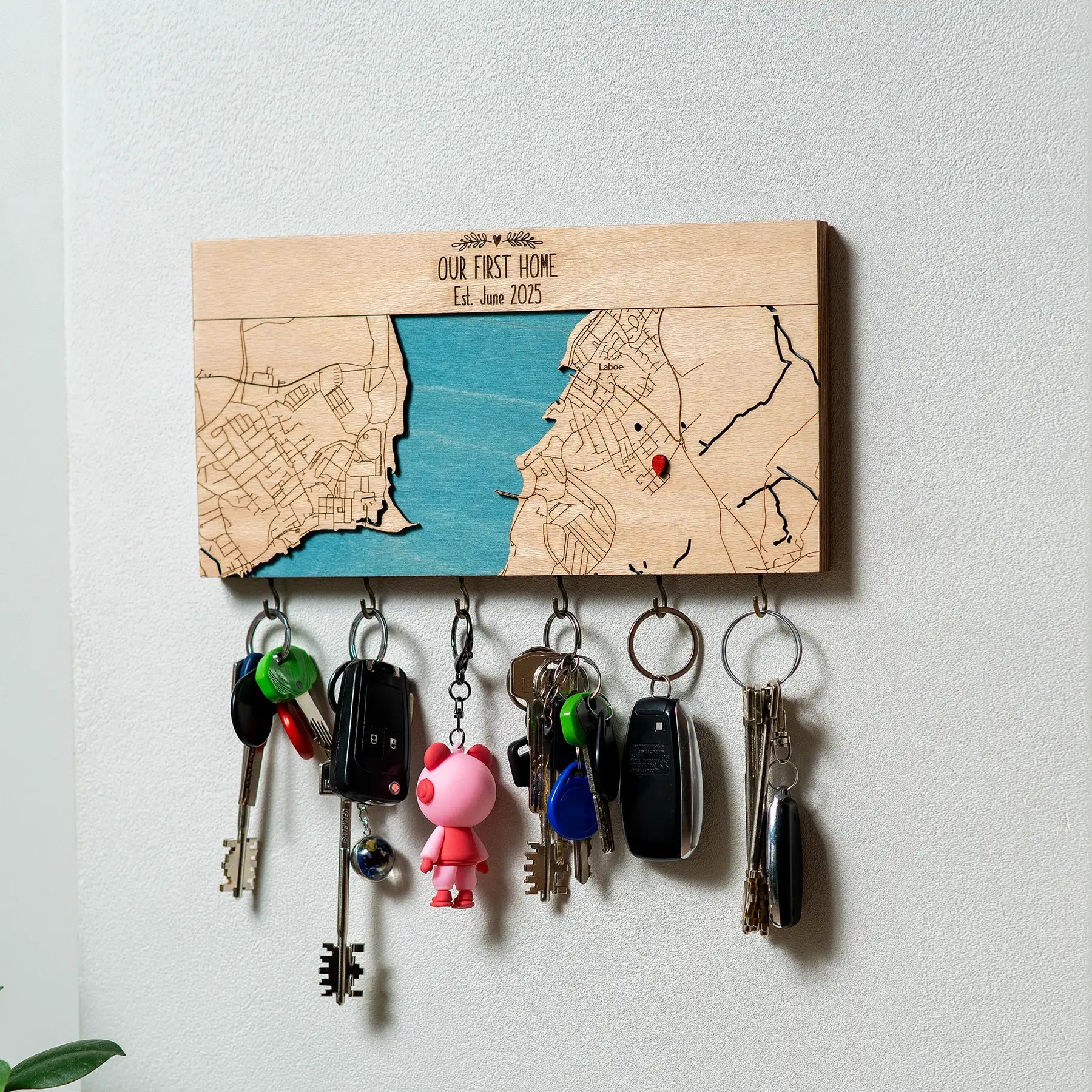 Wall mounted wooden key holder with hooks personalized as first home entryway organizer with hanging keys