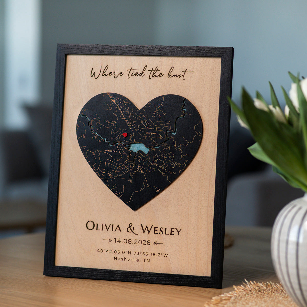 Personalized map wedding gift for couple with black oak frame, heart-shaped 3D wooden map, names, date, and red pin.