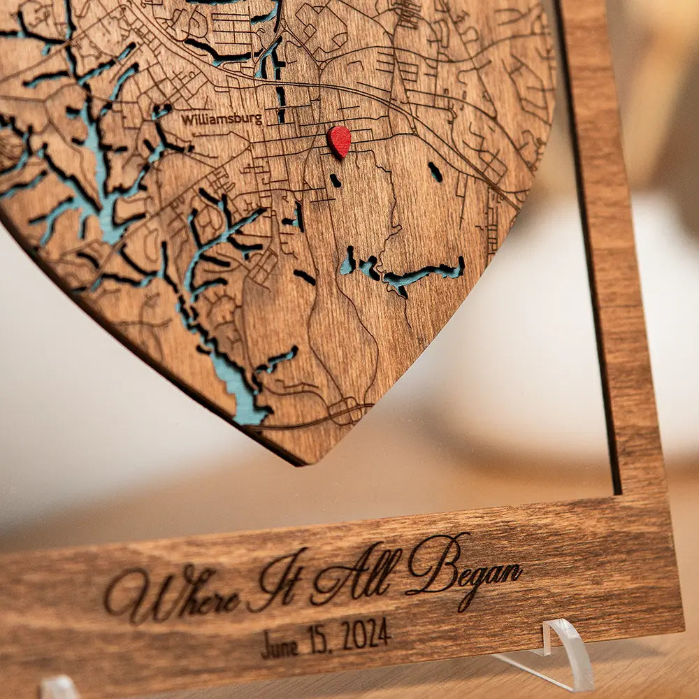 Close-up of personalized wooden Where It All Began map with engraved details and red location pin