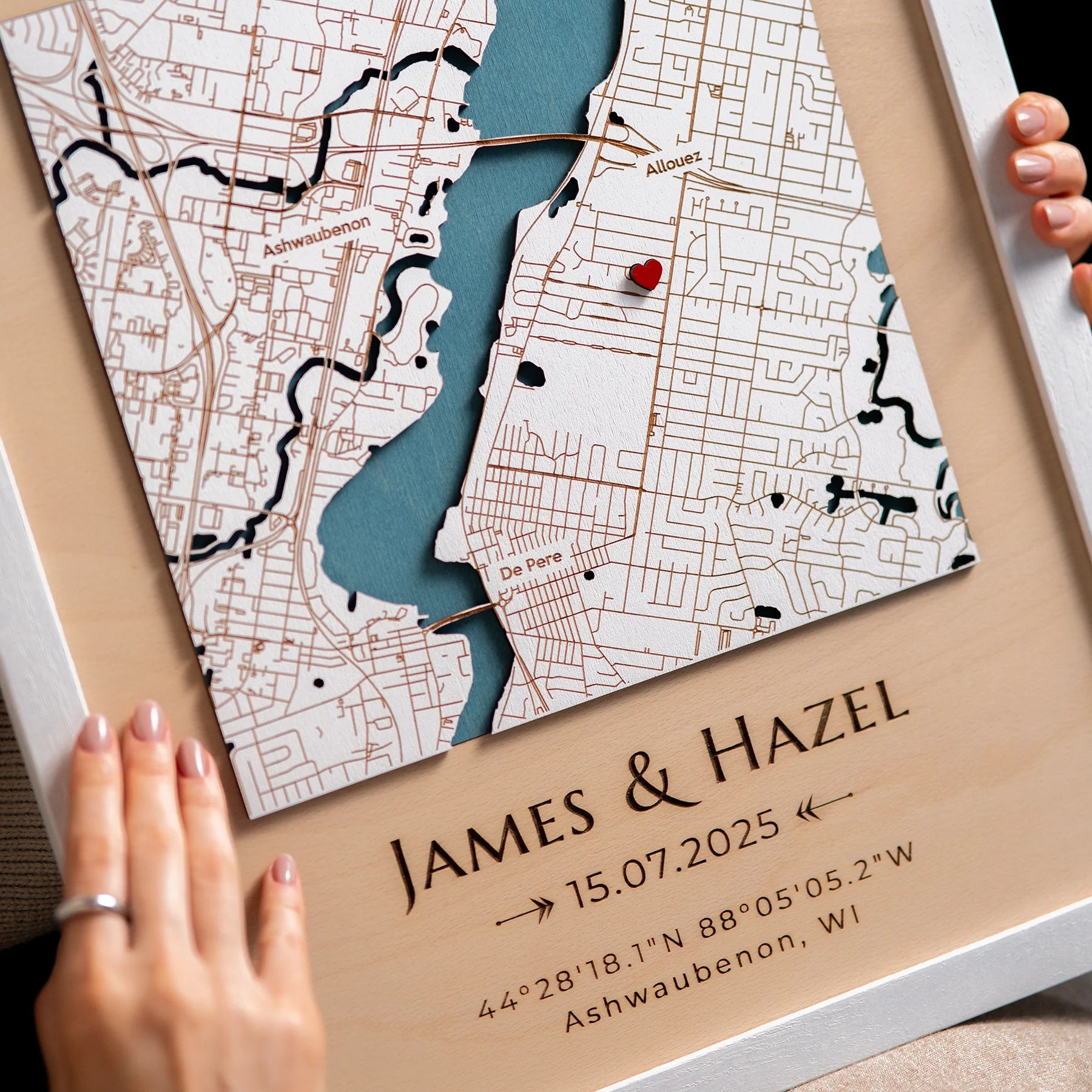 Close-up of personalized Where We First Met map with engraved names date and red heart pin
