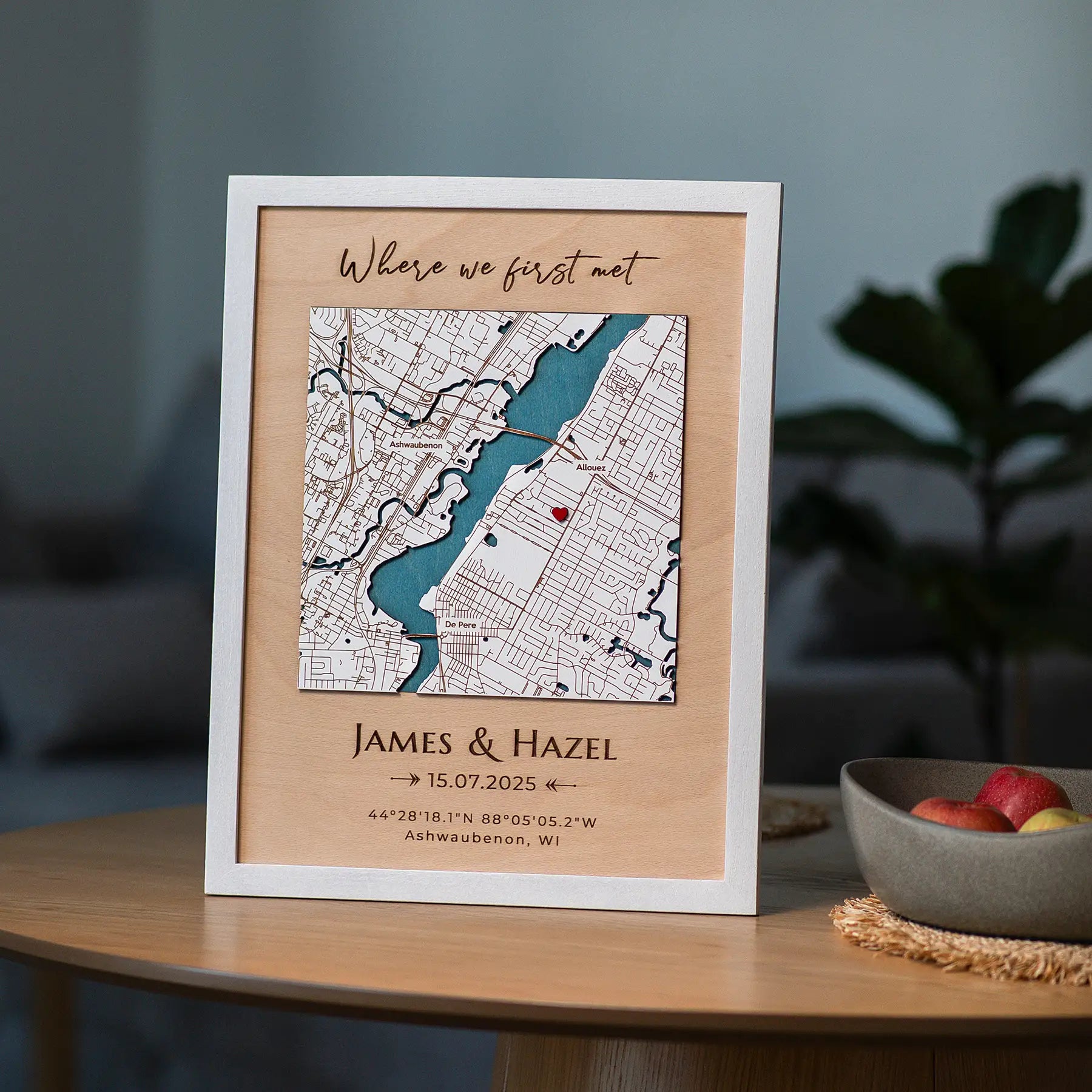 Where We First Met map in white frame styled as romantic home decor on table