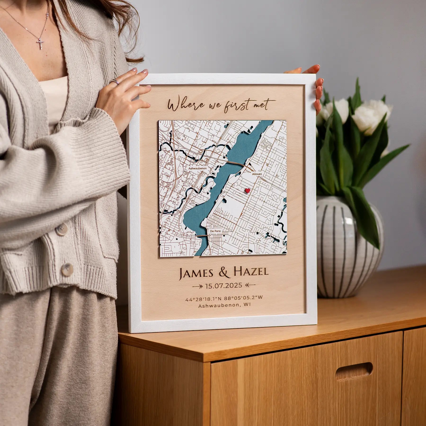 Personalized Where We First Met map in a white frame displayed on the cabinet with tulips