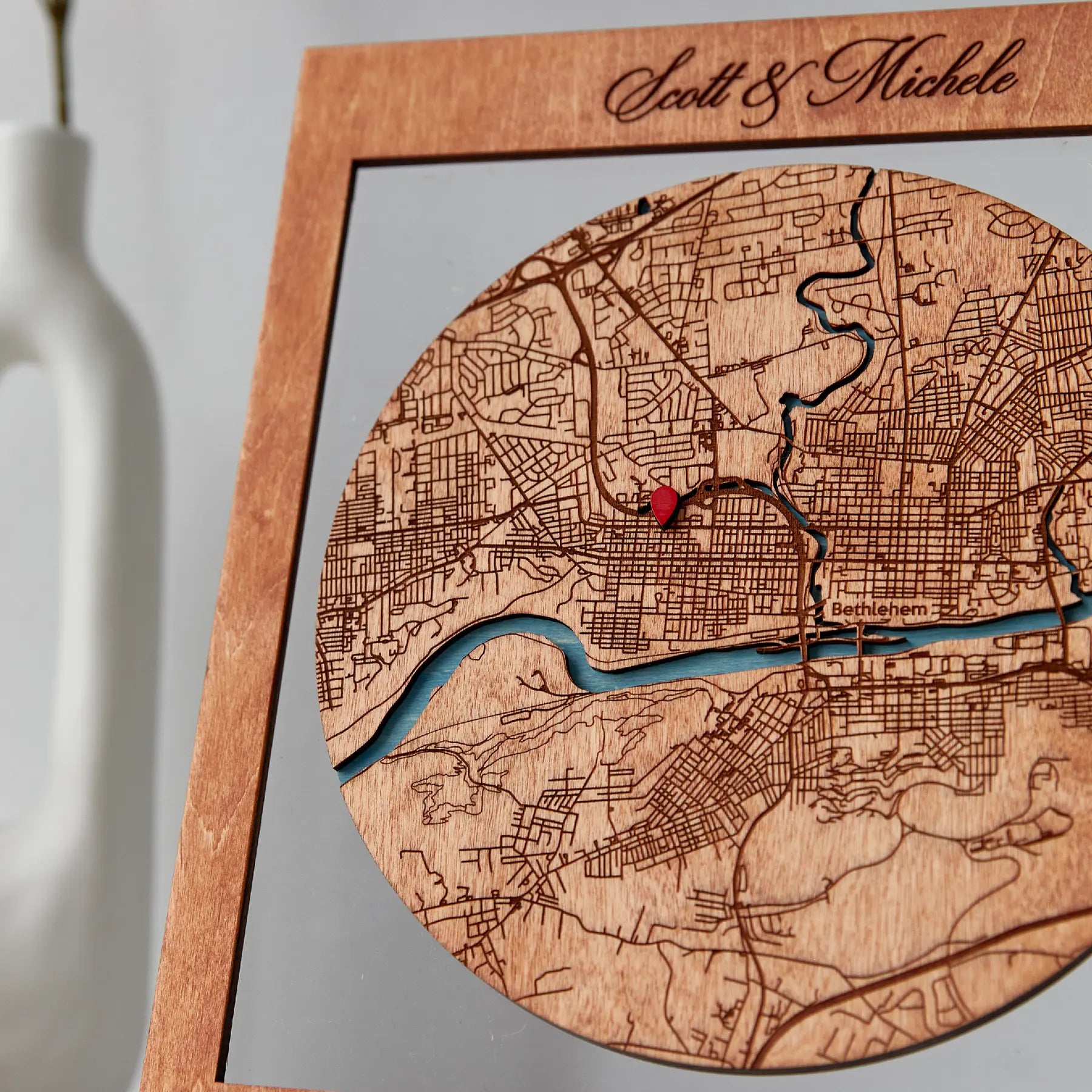 Close-up of Where We Met map gift for couples with engraved custom city map details and red pin
