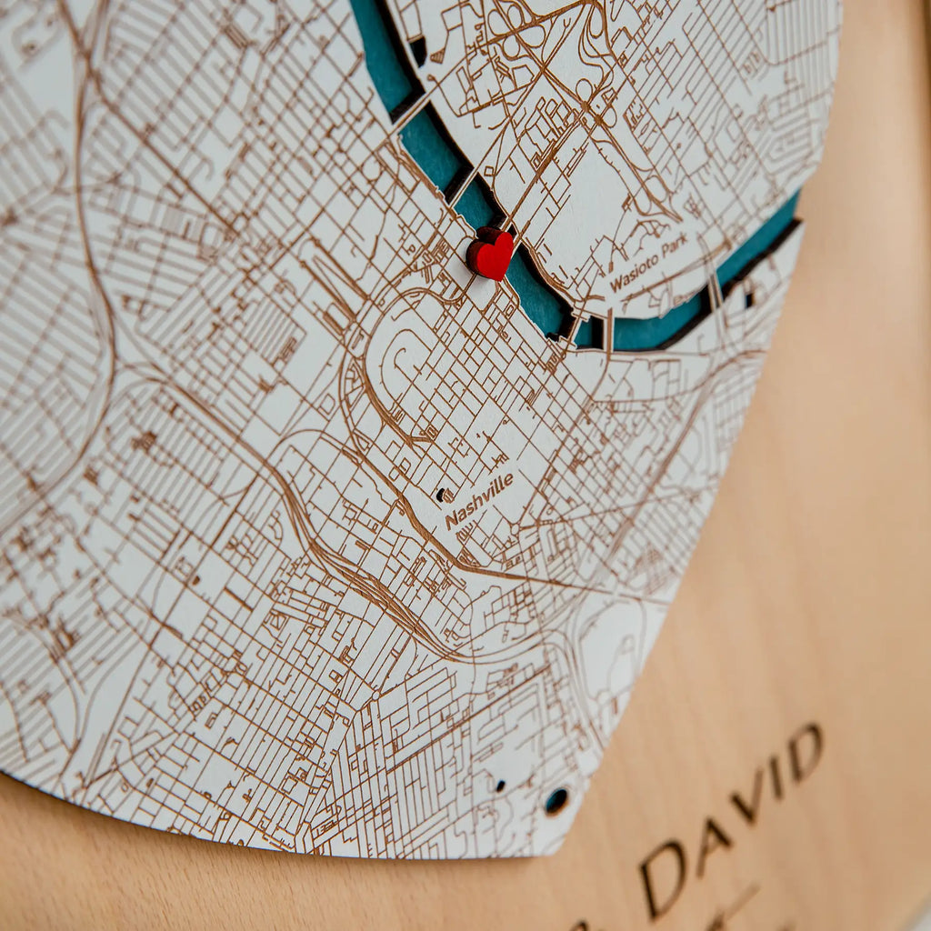 Close-up of personalized Where We Met plaque map with engraved city details and heart location pin