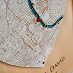 Close-up of personalized Where We Met plaque map with engraved city details and heart location pin