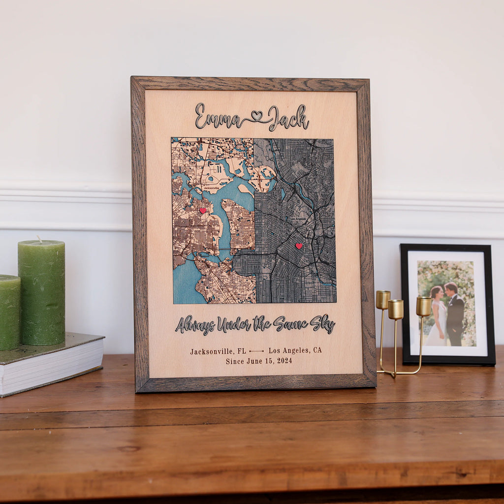 Wooden anniversary gift for him styled on a shelf with custom map, couple names, date, and oak frame.