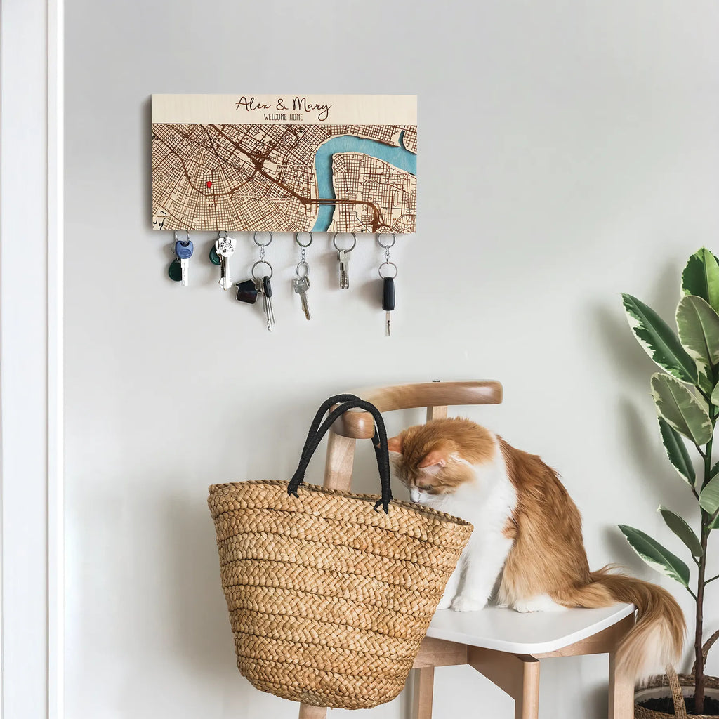 Wooden key holder for wall with personalized map design displayed in entryway with keys and cat