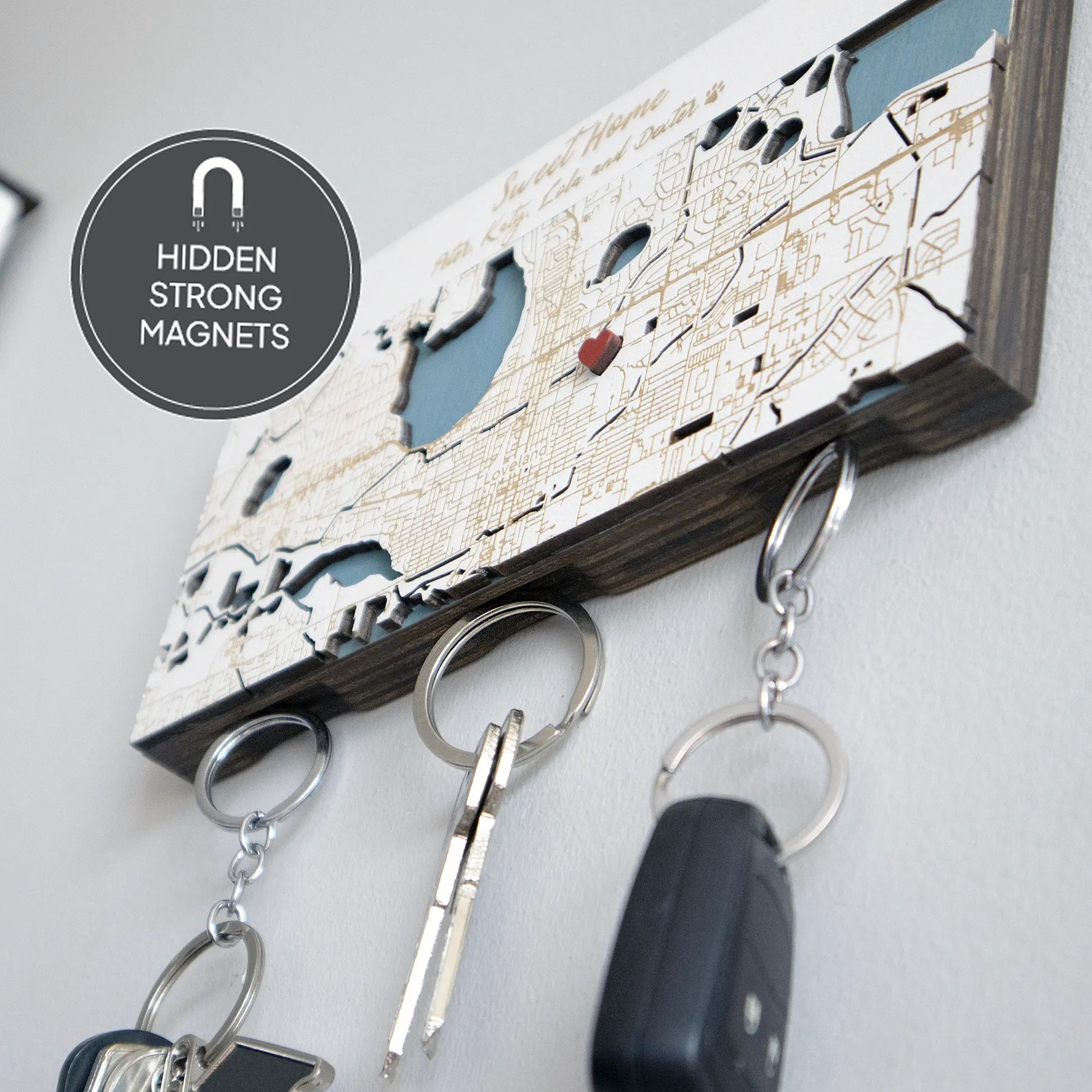 Close-up of wooden key holder for wall showing hidden strong magnets and hanging keys