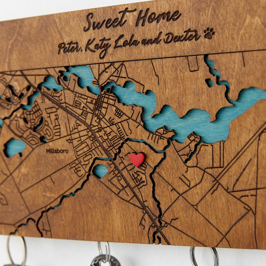Close-up of wooden key holder for wall with personalized map design and heart location marker